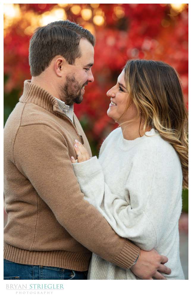 red fall leaves in engagement photo